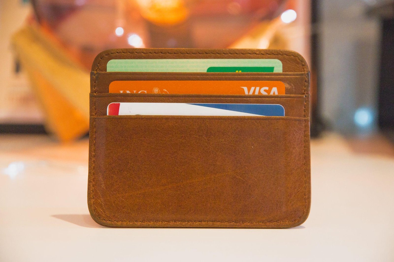 A brown wallet with credit cards inside

Description automatically generated