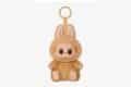 A cute stuffed animal keychain featuring a rabbit face, labeled "Have a Seat Labubu."