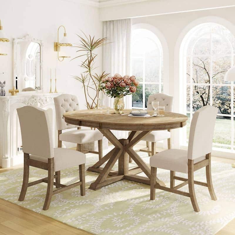 A cozy dining room featuring a table, chairs, and a decorative rug underneath.