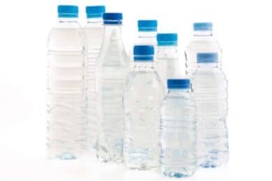 Several plastic water bottles arranged on a white background, showcasing their clear design and labels.