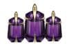 Three elegant purple perfume bottles with gold accents, featuring 'Alien the Fragrance' branding.
