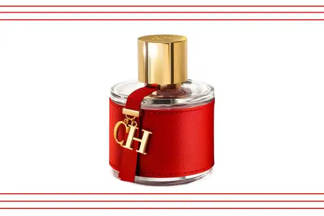 A striking red perfume bottle featuring gold lettering, labeled "CH Fragrances."