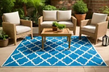 A stylish blue outdoor rug with white and blue details, ideal for patios or gardens.