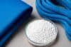 A bowl of white powder sits beside a blue cloth, indicating the material is nylon plastic.