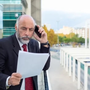 A businessman in a suit and tie talks on his cell phone, focusing on protecting IP while expanding into the French market.