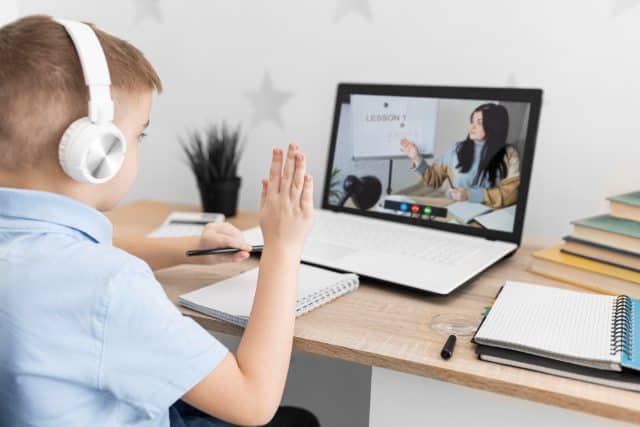 A student engaging in K12 online learning with a laptop and digital resources.