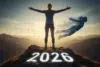 Woman standing triumphantly on a mountain peak with "2020" written on it, symbolizing overcoming challenges for 2026.