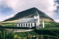 Good Shepherd Church in Iceland with a majestic mountain backdrop.