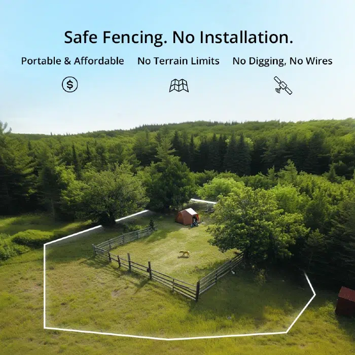 Aerial view of a safe, portable animal paddock in a green landscape, featuring a tent and a dog in a fenced area.