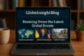 A laptop displays the GlobeInsightBlog homepage, featuring sections on global economic outlook, political crises, and regional conflict.