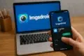 A person holds a smartphone displaying the Imgsdroid app, with a laptop in the background featuring the Imgsdroid logo.