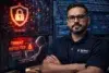 A confident man stands with folded arms in a cybersecurity center, displaying screens with a red shield, "Threat Detected" alert, and a countdown.