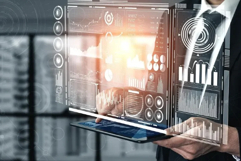 A person holds a tablet displaying a glowing virtual interface with graphs, charts, and data visualizations, conveying a futuristic and analytical tone.