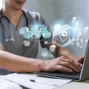 A healthcare professional in scrubs types on a laptop with futuristic, glowing medical icons above the keyboard, conveying innovation and technology.