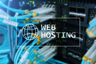 Blurry close-up of blue network cables connected to a server. Overlay text reads "Web Hosting" with a globe icon, conveying a tech-focused theme.