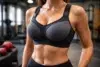 Biggest Bra Size high impact sports bra fit showing firm band, supportive cups, and wide straps in a gym setting