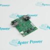 A green circuit board with various electronic components is placed on a white surface with repeated blue "Apter Power" logos in the background.