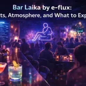 Dimly lit bar with neon art and crowd, vibrant drinks on the counter. Text reads: "Bar Laika by e-flux: Events, Atmosphere, and What to Expect."