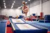 What is Double Mini Trampoline athlete performing a mount and dismount routine on the double mini trampoline with a controlled landing