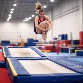 What is Double Mini Trampoline athlete performing a mount and dismount routine on the double mini trampoline with a controlled landing