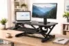 What is a Riser Desk showing a desk converter raising a monitor and keyboard for standing work