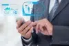 A businessman in a suit interacts with a smartphone displaying holographic data related to science and health.