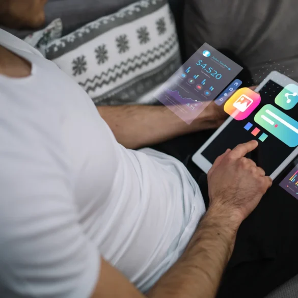 A person in a white shirt uses a tablet displaying holographic financial graphs and app icons, conveying a futuristic and tech-savvy atmosphere.