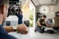 Mechanic performing an oil change while comparing how long does an oil change take at shops vs DIY