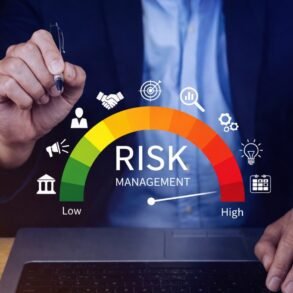 A person in a suit holds a pen above a risk management gauge, ranging from low to high, with business icons. The tone is professional and analytical.