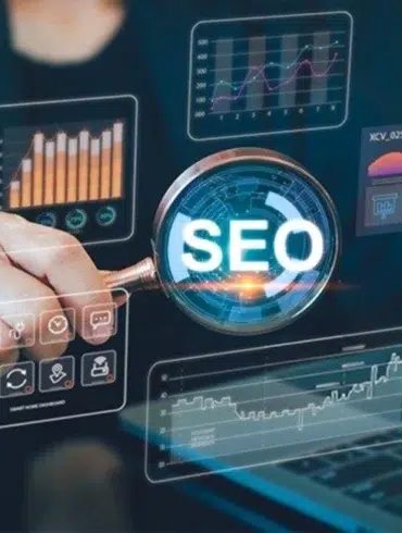 A person holds a magnifying glass revealing "SEO" amidst glowing digital graphs and charts, conveying data analysis and a focus on search engine optimization.