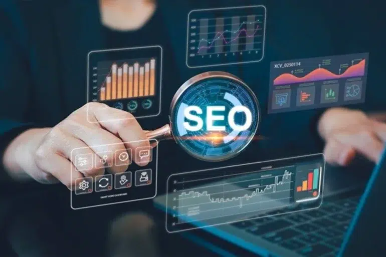 A person holds a magnifying glass revealing "SEO" amidst glowing digital graphs and charts, conveying data analysis and a focus on search engine optimization.