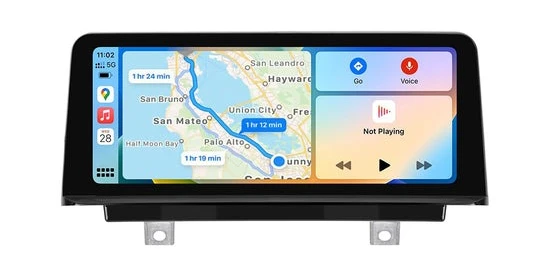 Car infotainment screen displaying a map route with estimated times, music app icon, and control panel for driving and music. Bright and modern interface.