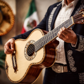 Bajo Quinto player performing a traditional regional Mexican string instrument on stage