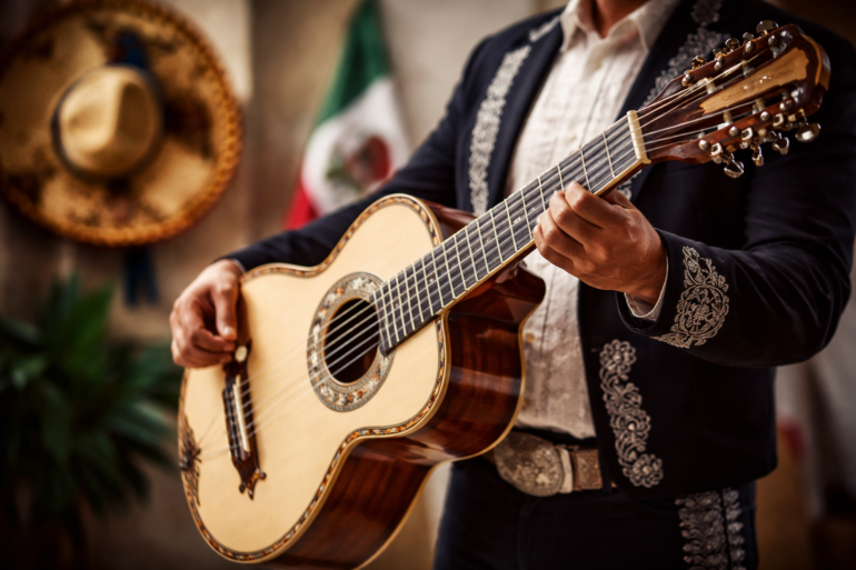 Bajo Quinto player performing a traditional regional Mexican string instrument on stage