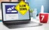 A laptop displays a progress bar with a rocket icon, overlaid by a yellow "Slow Down" sign. A red mug with "7" sits nearby, suggesting a cautionary tone.