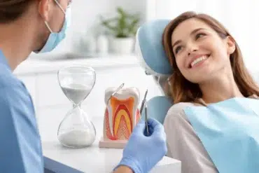 A dental professional performing a root canal procedure on a patient to explain how long does a root canal take.
