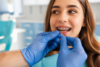 Orthodontic patient wearing Power Chain Braces to close gaps and improve tooth alignment