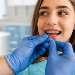 Orthodontic patient wearing Power Chain Braces to close gaps and improve tooth alignment