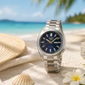 A woman in a white shirt checks her watch, standing in a modern urban setting with glass architecture in the background, appearing focused.