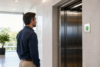 This Sign Shows When a Lift Is Safe to Use with a visible elevator inspection certificate inside a modern building lift