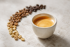 What Is Blonde Espresso in a ceramic cup with light roast espresso beans beside it