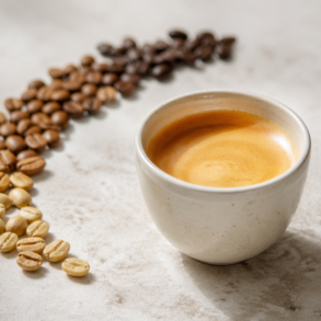 What Is Blonde Espresso in a ceramic cup with light roast espresso beans beside it
