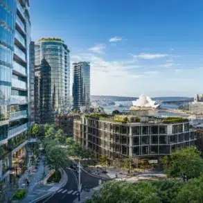 A vibrant cityscape featuring modern glass buildings, a lush rooftop garden, Sydney Opera House, and the Harbour Bridge under a clear blue sky.