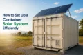 A shipping container with solar panels on top sits on a grassy landscape under a clear blue sky.