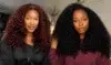 Two women with voluminous curly hair, one with dark red curls and the other with black curls, indoors with a neutral background.