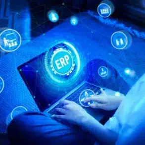 ERP Systems interface displayed on a laptop with connected business icons, illustrating digital management and workflow automation