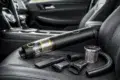 A sleek, portable vacuum cleaner with attachments is arranged on a car seat. The modern design conveys functionality and convenience.