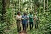 Forestry Development Authority officials inspecting a protected forest area with local community members