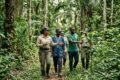 Forestry Development Authority officials inspecting a protected forest area with local community members