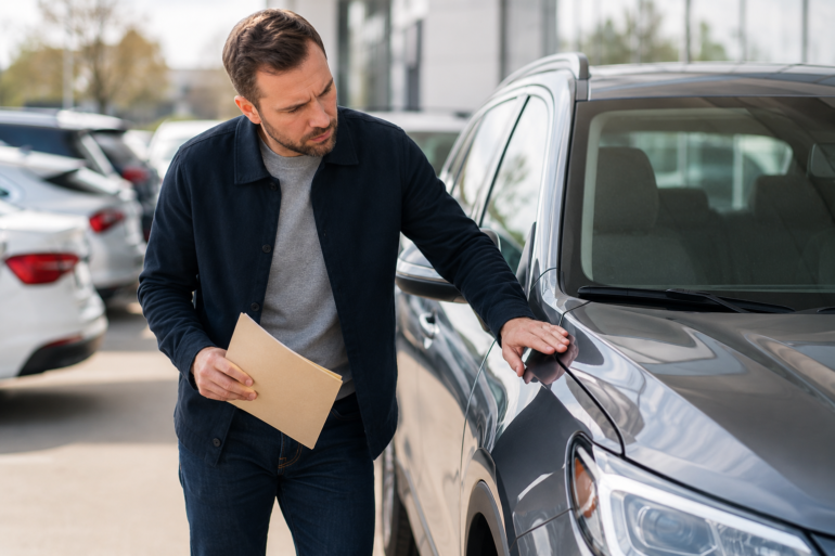 Customer reviewing a vehicle at Gervais Auto before making a car-buying decision